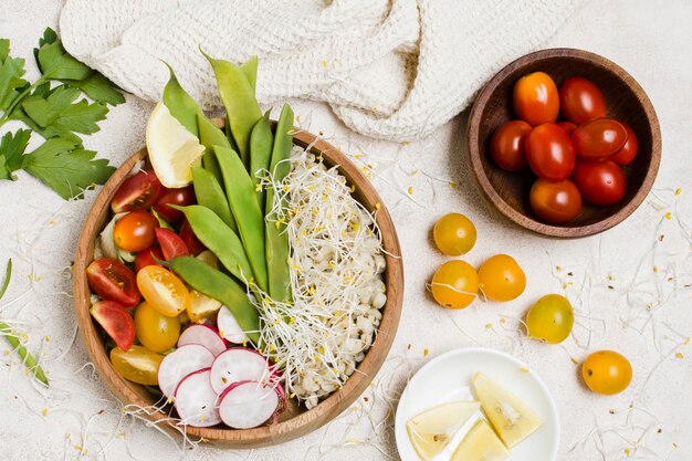 Top view of tomatoes in bowl with healthy food