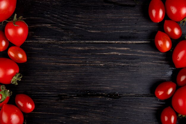 Top view of tomatoes on left and right sides and wood with copy space