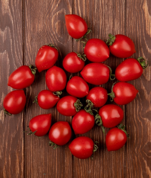 Top view of tomatoes on wooden surface