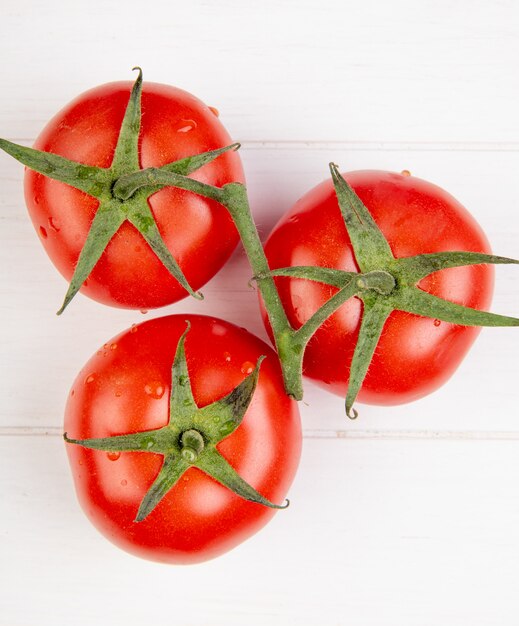 Top view of tomatoes on wooden surface