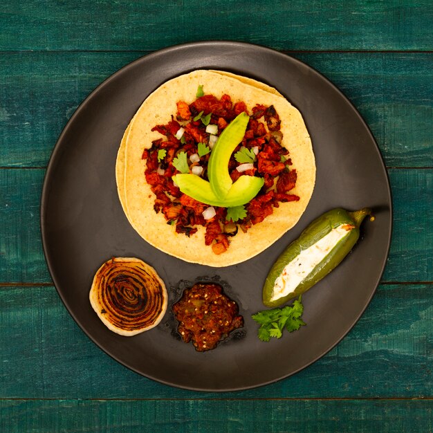 Top view tortilla in a plate with ingredients