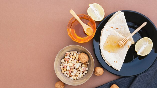 Top view tortillas on a plate with honey