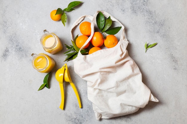 Top view tote bag with oranges and juice