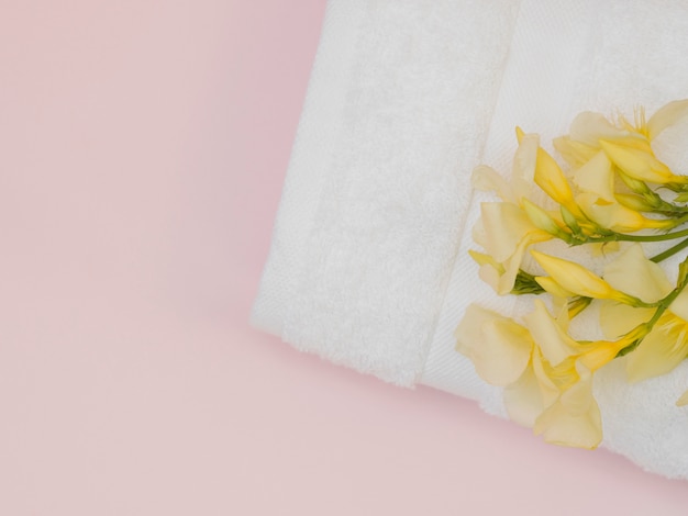 Free photo top view of towel with yellow flower