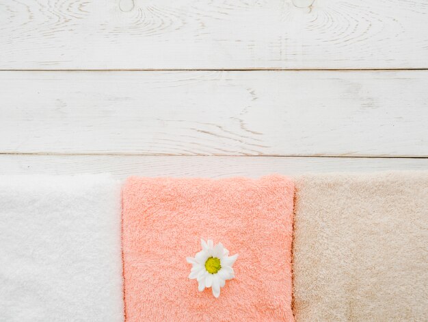 Top view towels on wooden background with copy space