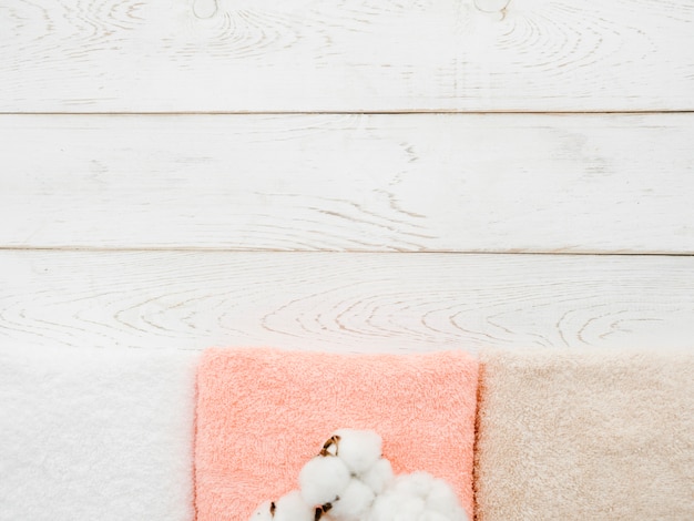 Top view towels on wooden background with copy space
