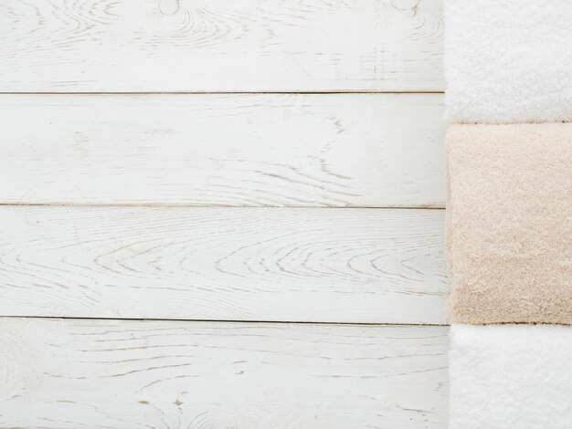  top view towels on wooden background with copyspace