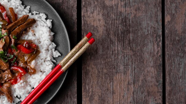 Top view of traditional asian rice dish with meat and copy space