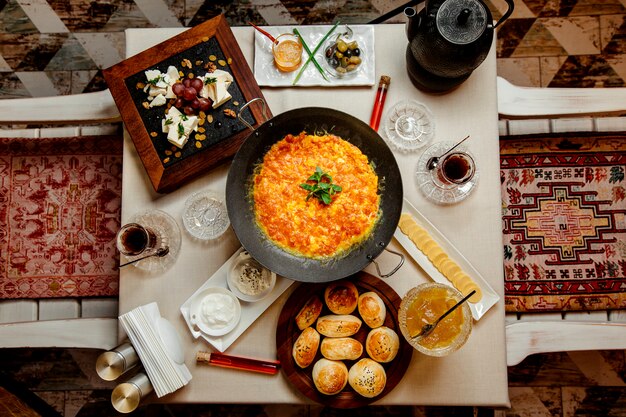 top view of traditional azerbaijani breakfast with egg and tomato dish
