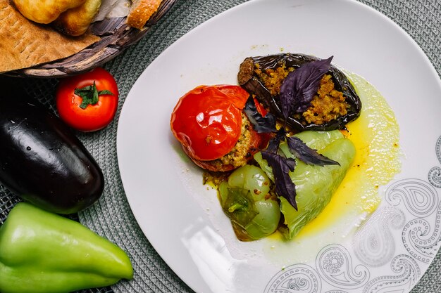 Top view traditional azerbaijani dish dolma stuffed vegetables with meat and basil