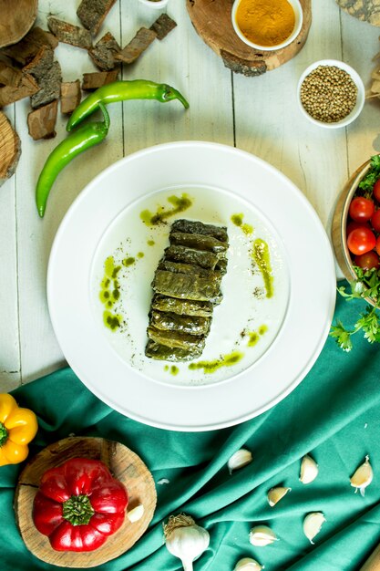 Top view of traditional caucasian cuisine dolma with grape leaves on a plate