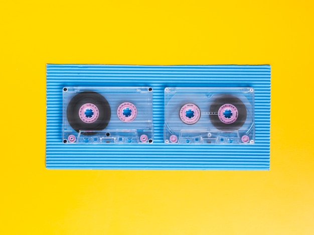 Top view transparent cassette tapes on vibrant background