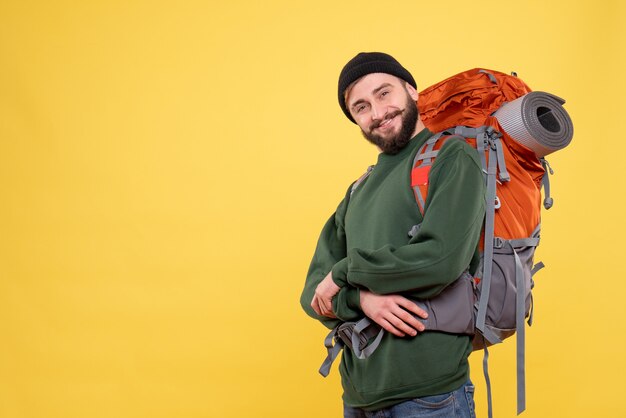 Top view of travel concept with smiling young guy with packpack