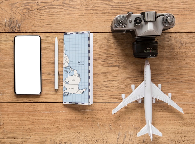 Top view traveling items on wooden background