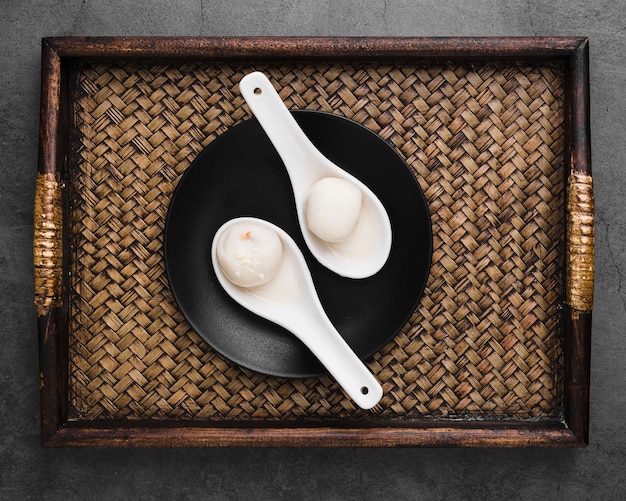 Top view of tray with dumplings in spoons