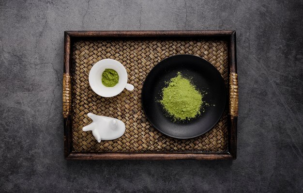 Top view of tray with matcha tea and plate