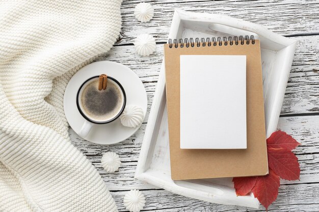 Top view of tray with notebook and cup of coffee