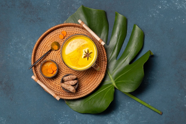 Free photo top view tray with yellow drink and star anise