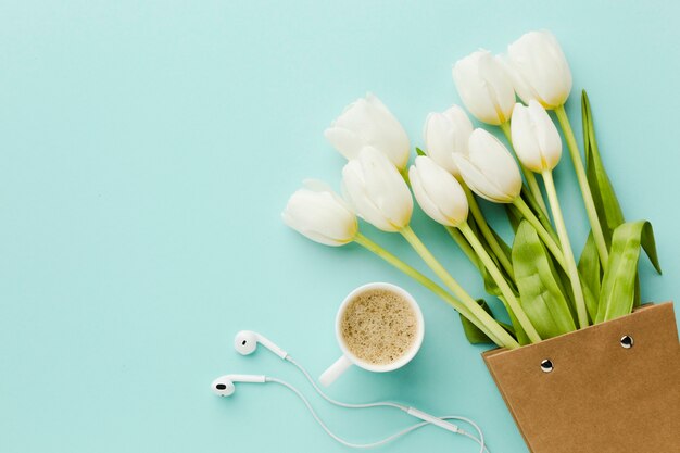 Top view tulip white flowers and coffee