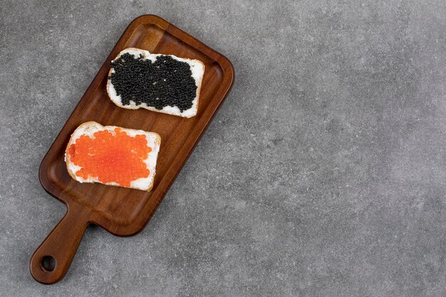 Top view of Two bread slices with fresh caviar. Top view