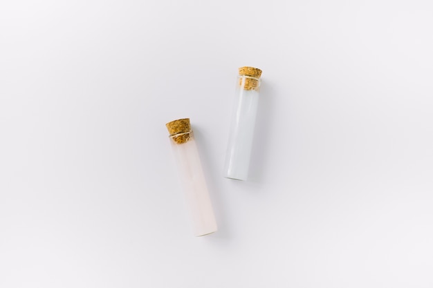 Top view of two essential oil test tubes on white surface