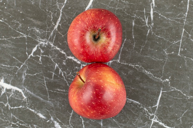 Top view of Two fresh apple on grey stone.