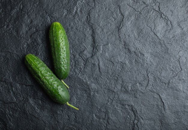 Top view two fresh cucumber on black background. 