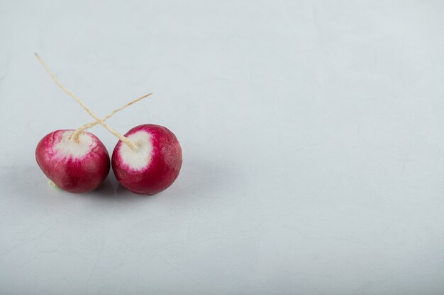 Top view of two fresh radishes on white background.