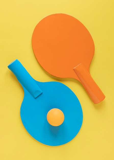 Top view of two ping pong paddles with ball