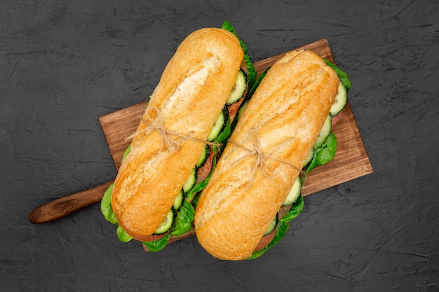 Free photo top view of two sandwiches on chopping board