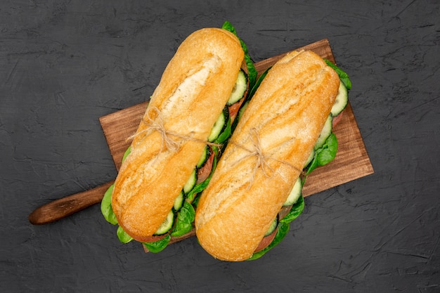 Top view of two sandwiches on chopping board