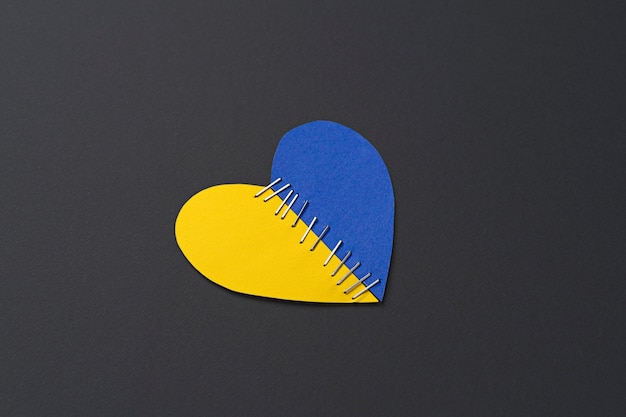 Top view ukrainian flag heart with stitches