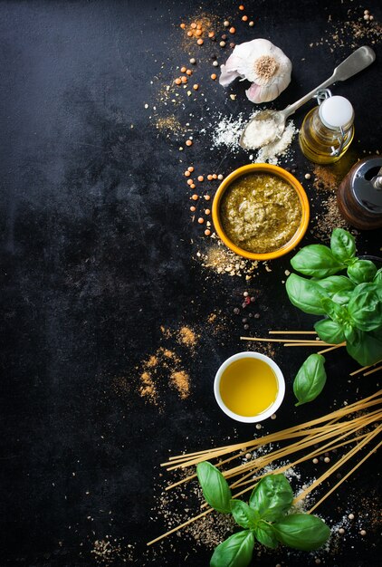 Top view of uncooked spaghetti with aromatic herbs