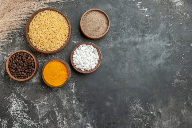 Top view of uncooked white rice and different spices