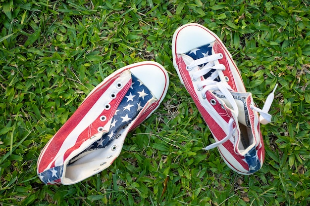Top view usa flag sneakers on grass