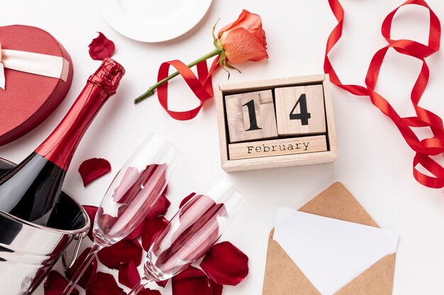 Top view valentine's day arrangement with champagne and glasses