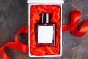 Free photo top view valentines day present fragnance on dark surface gift perfume love feeling color lover couple