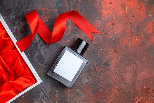 Top view valentines day present fragnance with package on dark surface couple gift perfume feeling color