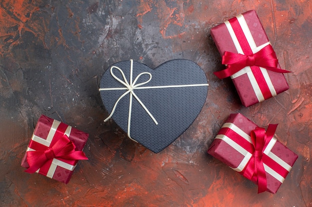 Top view valentines day presents in red package on the dark surface