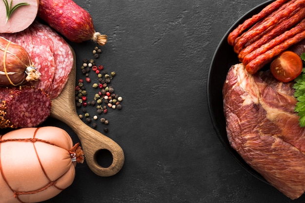 Top view variety of fresh meat and sausages on the table