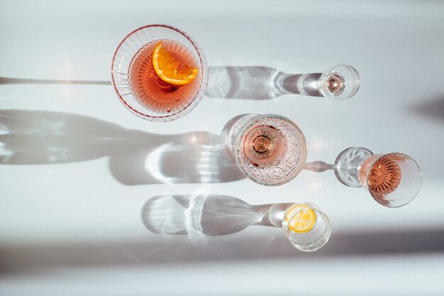 Top view of various cocktails on a white table