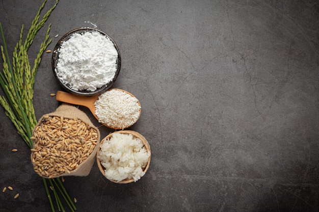 Top view of various kinds of produce from rice on dark floor