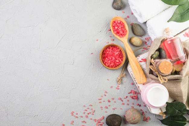 Top view of various spa products on grey background