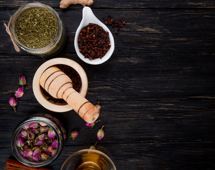 Free Photo top view of various spices and herbs on black wood with copy space