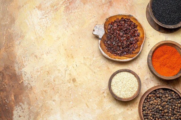 Top view of various spices in small brown pots