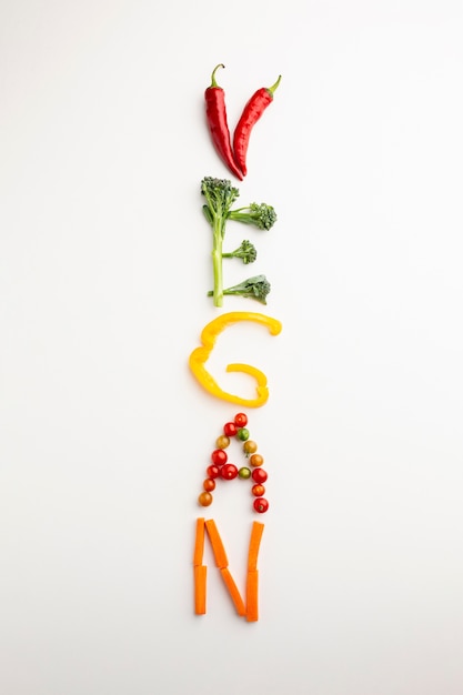 Free photo top view vegan lettering made out of vegetables