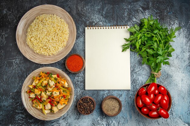 Top view vegetable chicken salad with tomatoes and greens on light desk