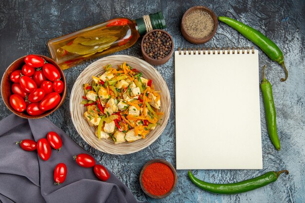 Top view vegetable chicken salad with tomatoes on a light desk