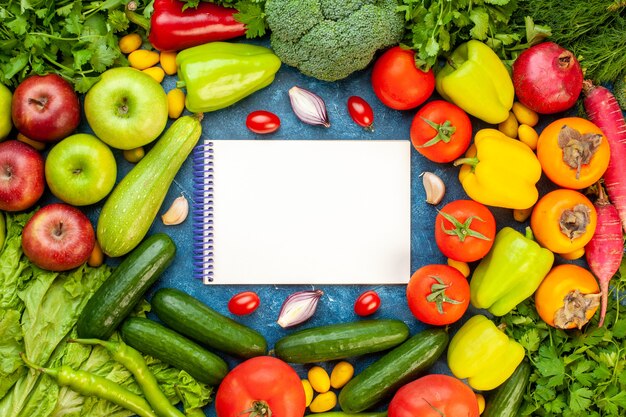 Top view vegetable composition with fresh fruits on blue desk color ripe diet salad healthy life meal