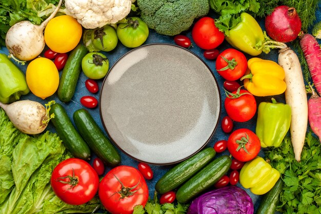 Top view vegetable composition with fresh fruits on the blue tablelor